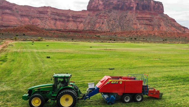 Baling hay with a John Deere 7930 tractor and a GPT Twin Pak baler on a ranch in southern Utah