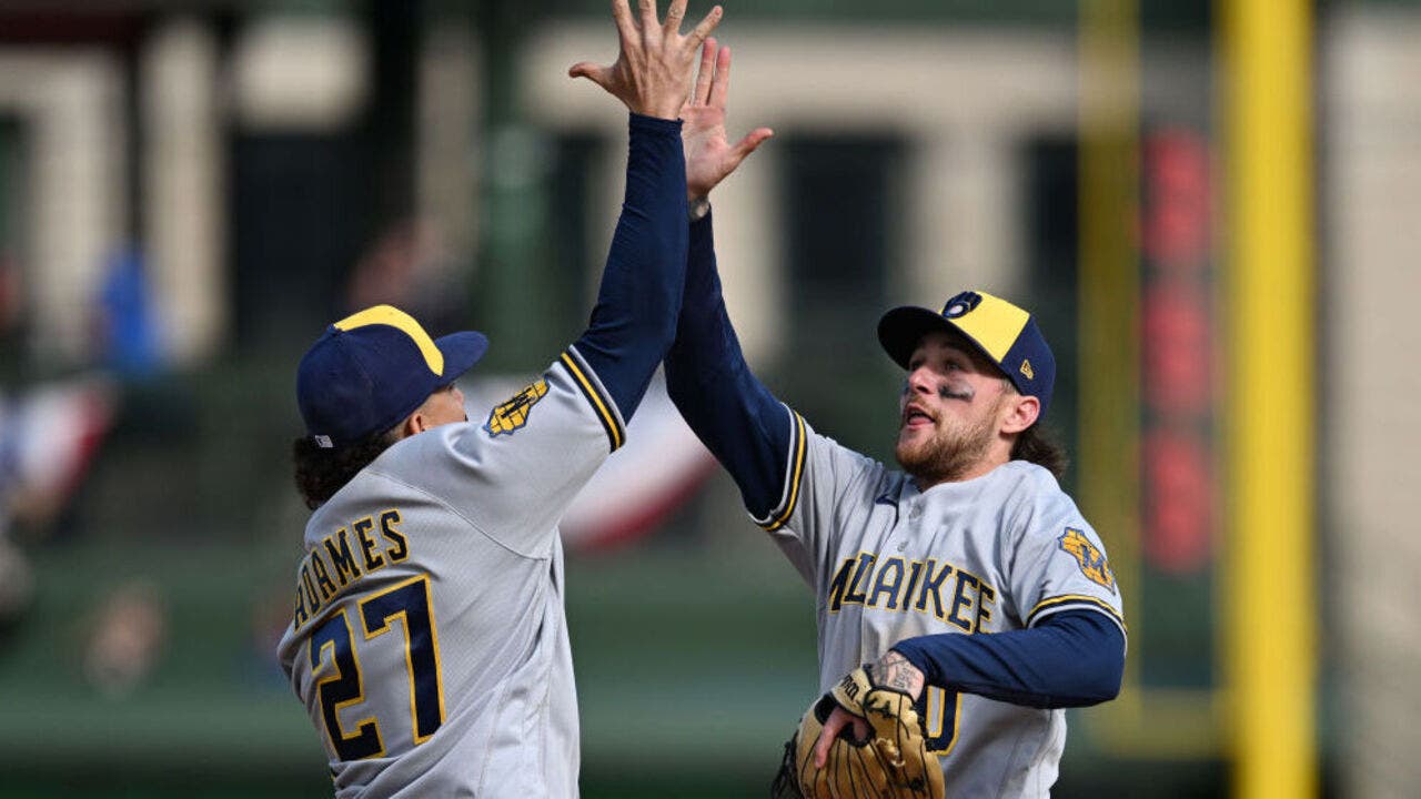 Milwaukee Brewers' Jesse Winker catches a fly ball hit by Chicago