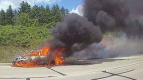Slinger car fire on Highway 60; flames spread to adjacent hill