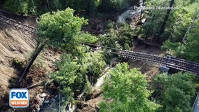 Aerial footage shows railroad tracks suspended in air after Vermont flooding wipes out trestle