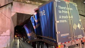 Amazon semi-truck slams into, gets stuck under Indiana bridge