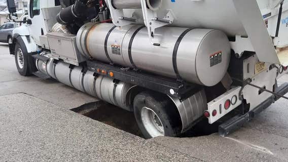 Truck falls into sinkhole in West Bend after repairing sewer line
