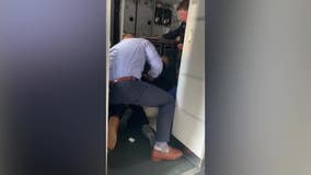 Milwaukee-Dallas flight video; passengers subdue 'disruptive' man