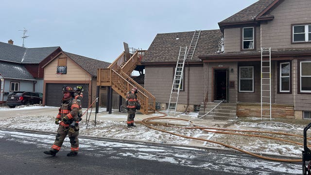 Sheboygan house fire; smoke seen from 2nd story of residence