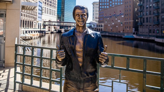 Henry Winkler birthday party, Milwaukee holding Bronze Fonz bash