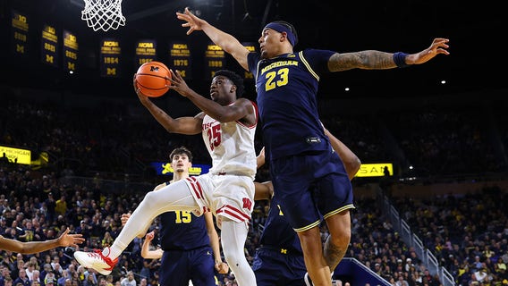 Wisconsin Badgers upset previously unbeaten Michigan on the road