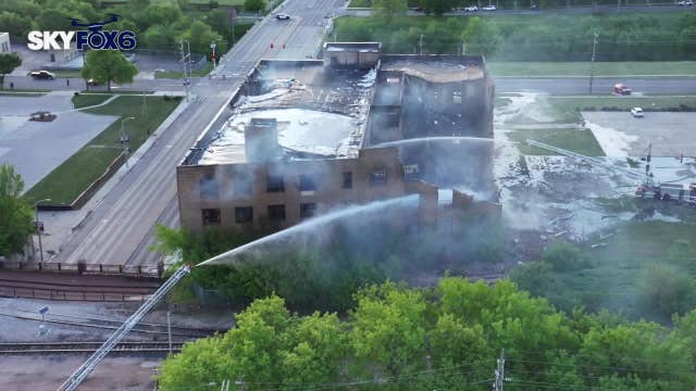 Milwaukee warehouse fire; woman arrested as raze order issued