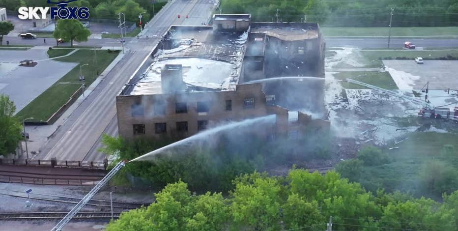 Milwaukee warehouse fire; woman arrested as raze order issued