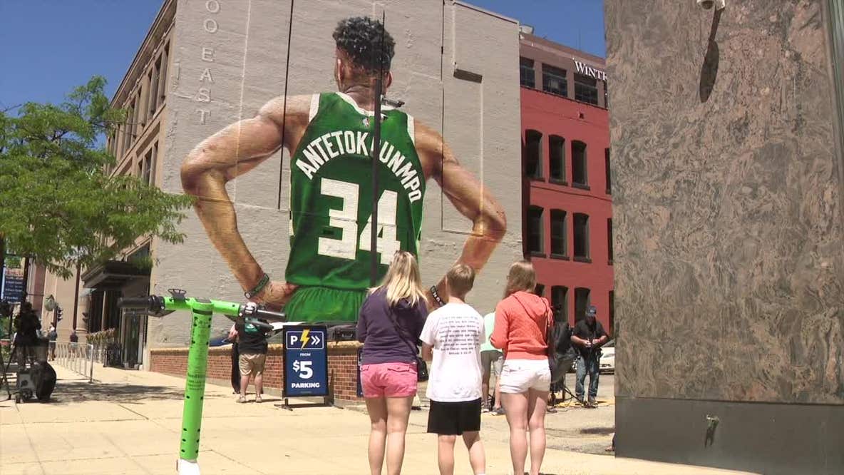 Giannis Antetokounmpo mural in downtown Milwaukee, fans gather