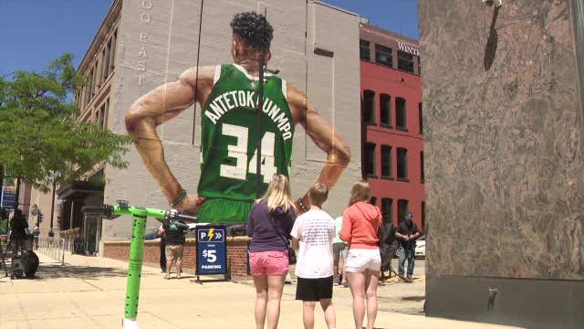 Giannis Antetokounmpo mural in downtown Milwaukee, fans gather
