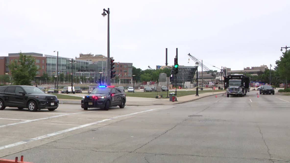 Milwaukee police shooting; officer struck by fleeing driver, later arrested