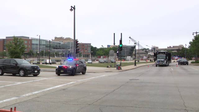 Milwaukee police shooting; officer struck by fleeing driver, later arrested