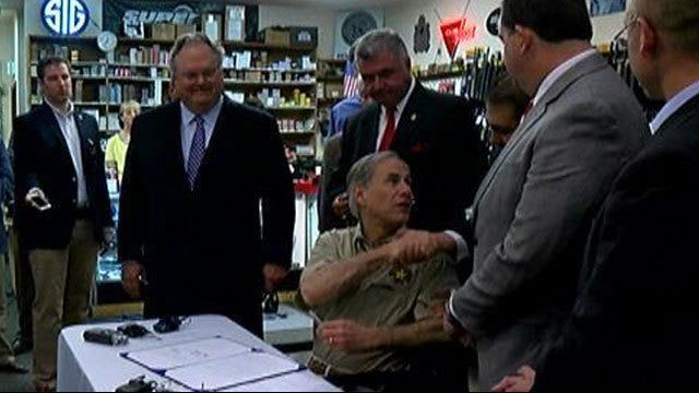 At a Pflugerville shooting range, Governor Abbott signs open and campus carry into law