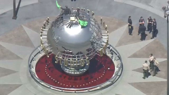 Climate activists climb, superglue themselves to globe at Universal Studios