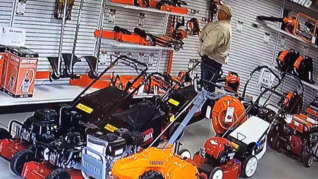 Surveillance camera catches man shoving chainsaw down his pants in order to steal it from store