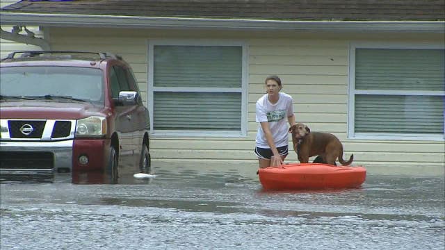 Family walks, kayaks across flooded yard to safety