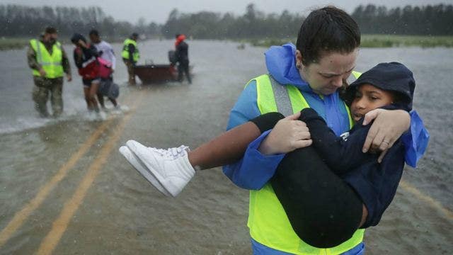 ‘I'm just your average mom:' Hurricane volunteer captured in poignant photo of rescuing 7-year-old