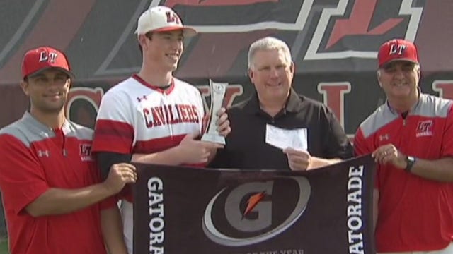 Lake Travis HS baseball player presents check to charity