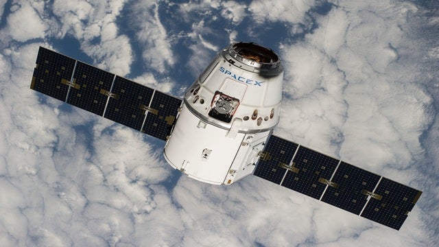 SpaceX says it will fly 2 people to moon next year