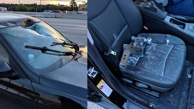 Tow hitch smashes through windshield, narrowly missing driver