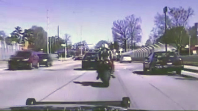 VIDEO: Motorcyclist wipes out in front of officer