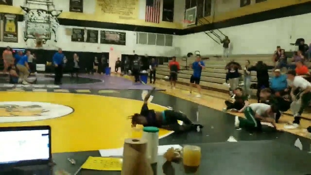 Teen falls through gym roof onto wrestling mat during match