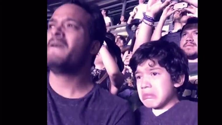 Boy with autism overcome with emotion at Coldplay concert, 1-402970