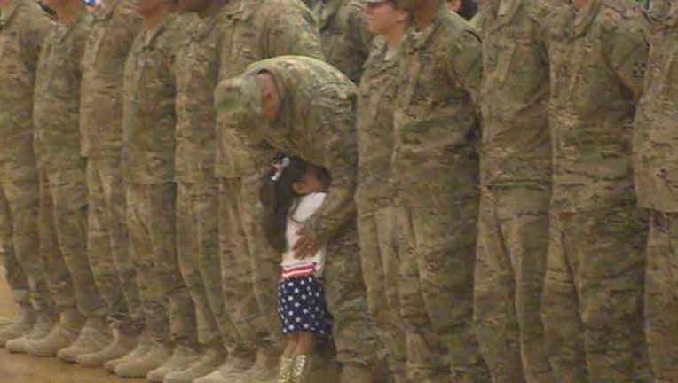 Girl Hugs Soldier Dad-402970