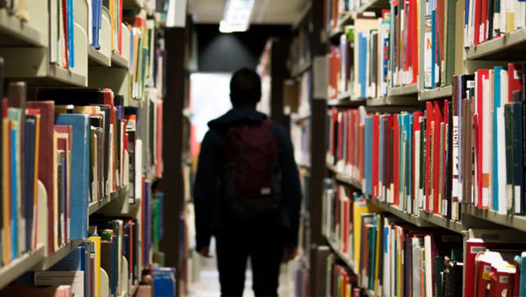 student in library