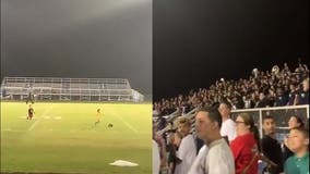 Crowd goes wild for pint-sized football players playing on field before high school game