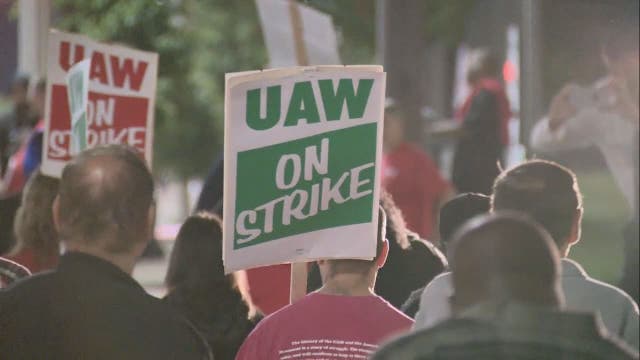 On strike: Union workers at General Motors walk off the job at midnight