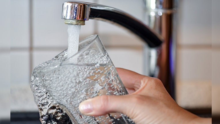 A drinking glass is filled from the tap. A new study found that contaminants in tap water cause an estimated 105,000 lifetime cancer cases in the U.S.