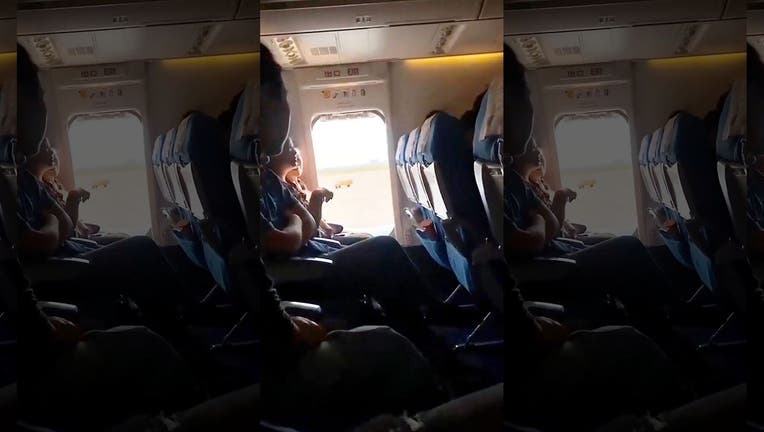 Though the passenger had been warned by flight attendants not to touch the lever on the emergency exit, which she was seated close to, she didn’t listen – and soon popped the door open. (Photo: AsiaWire)