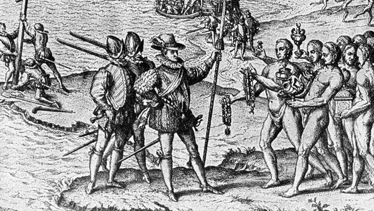 1492, Christopher Columbus lands on Watling Island and meets the natives, while three of his shipmates erect a cross.