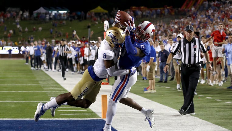 James Proche #3 of the Southern Methodist Mustangs makes the game winning touchdown pass against Brandon Johnson #8 of the Tulsa Golden Hurricane in overtime at Gerald J. Ford Stadium on October 05, 2019 in Dallas, Texas. (Photo by Ronald Martinez/Getty Images)