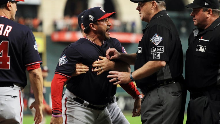 HOUSTON, TEXAS - OCTOBER 29: Dave Martinez #4 of the Washington Nationals argues as he is ejected by the umpire and is held back by Bob Henley #14 against the Houston Astros after the top of the seventh inning in Game Six of the 2019 World Series at Minute Maid Park on October 29, 2019 in Houston, Texas.