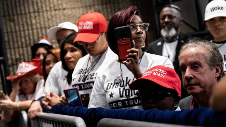 People wait for US President Donald Trump during a rally at the Georgia World Congress Center to court African American votes November 8, 2019, in Atlanta, Georgia. (Photo by Brendan Smialowski / AFP) (Photo by BRENDAN SMIALOWSKI/AFP via Getty Images)