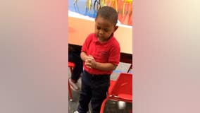 Toddler leads preschool lunch prayer before enjoying a meal with classmates