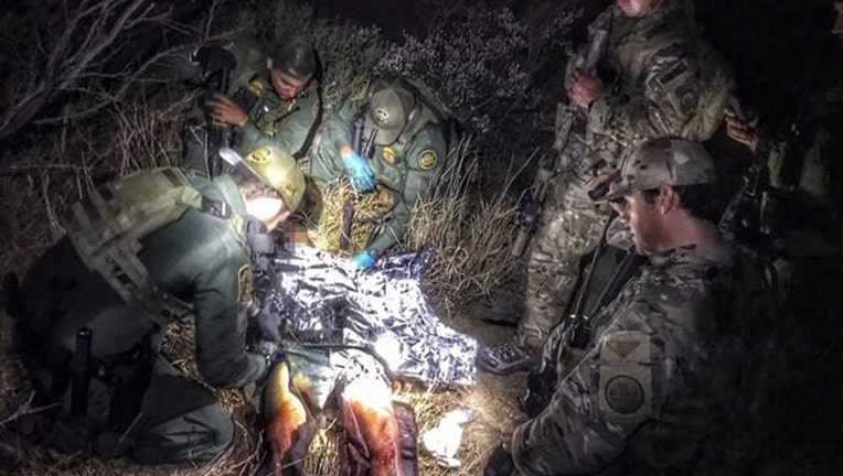 Border Patrol agents treat a man with gunshot wounds. The man had crossed the border from Mexico into the U.S. near Del Rio, Texas, Jan. 9, 2020.