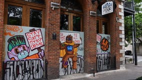 Art painted on boarded-up windows of downtown bars as part of HOPE for Health Campaign