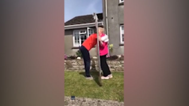 Teen embraces grandma for first time in over 2 months through plastic sheet amid COVID-19 quarantine