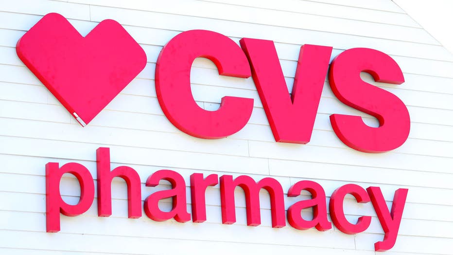FILE - A sign on the side of the CVS Pharmacy on May 15, 2020 in Carver, Massachusetts. Nine CVS locations began providing coronavirus tests in Massachusetts, issuing self swab tests to people by appointment. 
