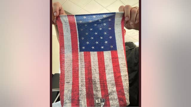 Air marshal says he was asked to remove his American flag face covering