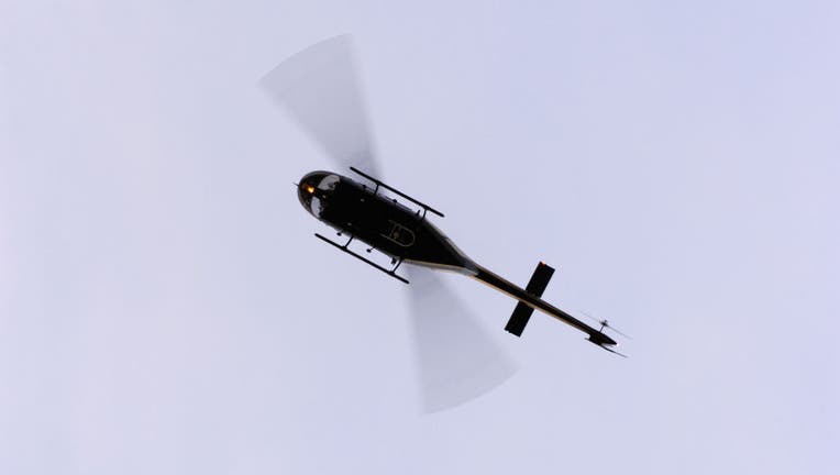 a Bell 206B Jet Ranger flying enroute at dusk