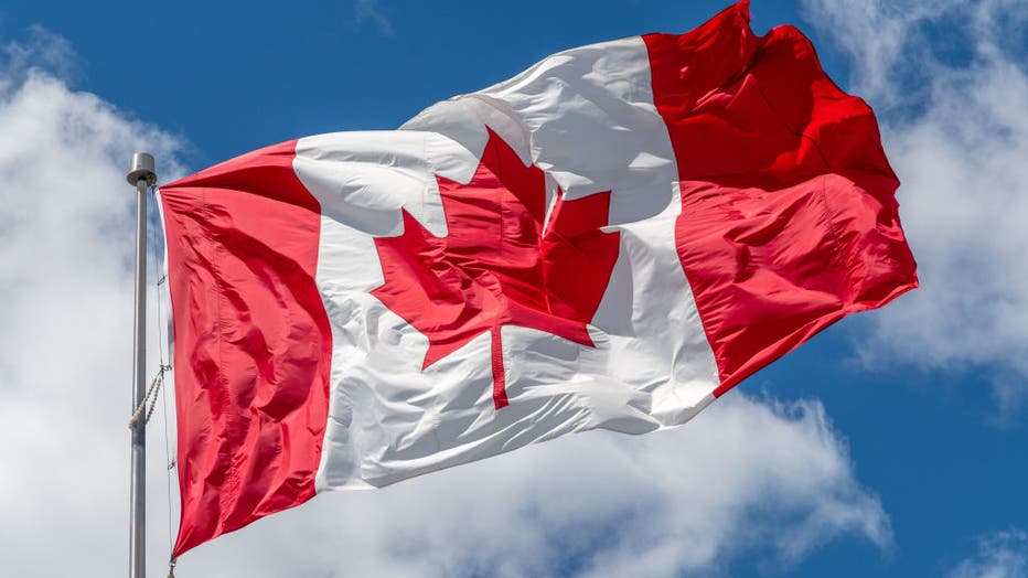 Canadian National flag waving on a clear sunny day