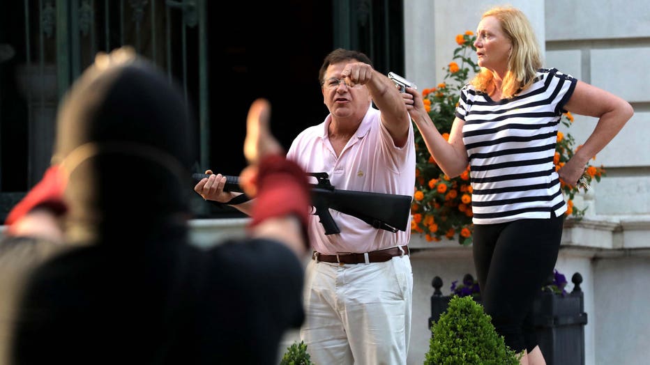 dc0a9b3c-The St. Louis couple charged with waving guns at protesters have a long history of not backing down