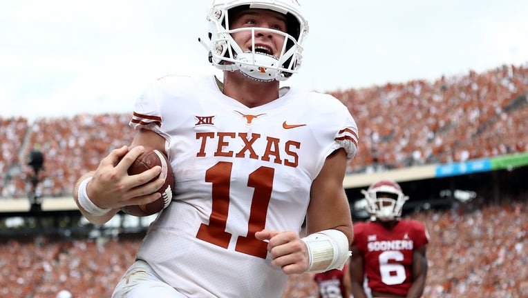 Sam Ehlinger #11 of the Texas Longhorns smiles as he runs into the endzone for a touchdown against the Oklahoma Sooners in the second quarter of the 2018 AT&T Red River Showdown at Cotton Bowl on October 6, 2018 in Dallas, Texas.