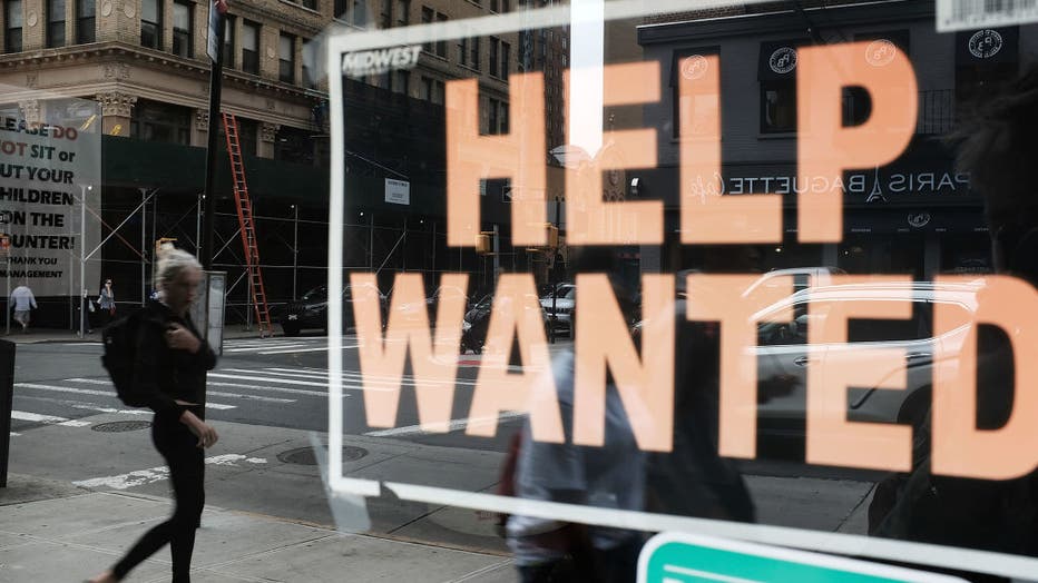 A help wanted sign is displayed in the window of a Brooklyn business on Oct. 5, 2018 in New York, United States. (Photo by Spencer Platt/Getty Images)