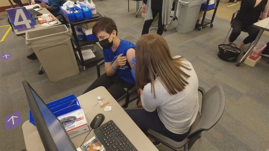 A teenager getting a COVID-19 vaccine in Minnesota