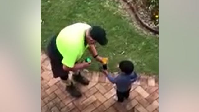 Sanitation worker, boy trade gifts in mutual acts of kindness